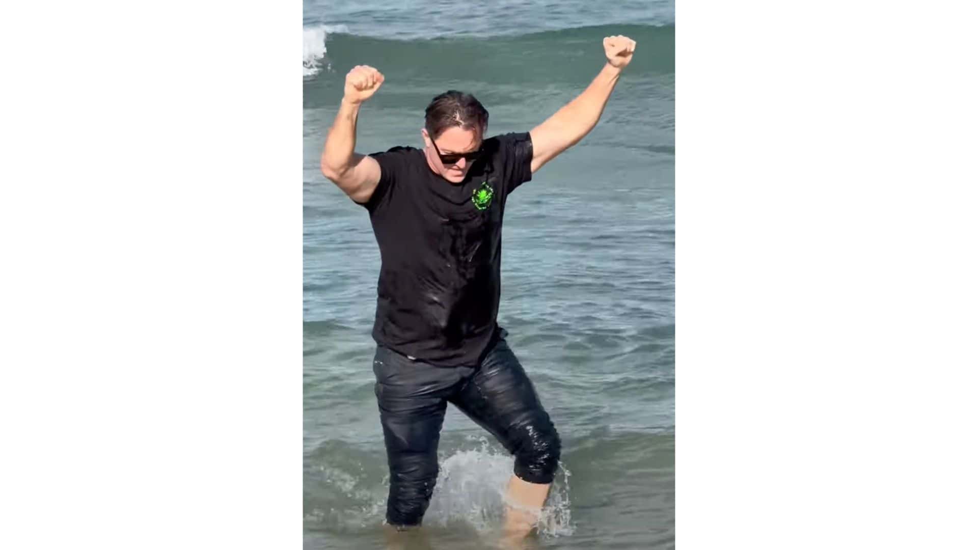 rugby player saves baby dolphin