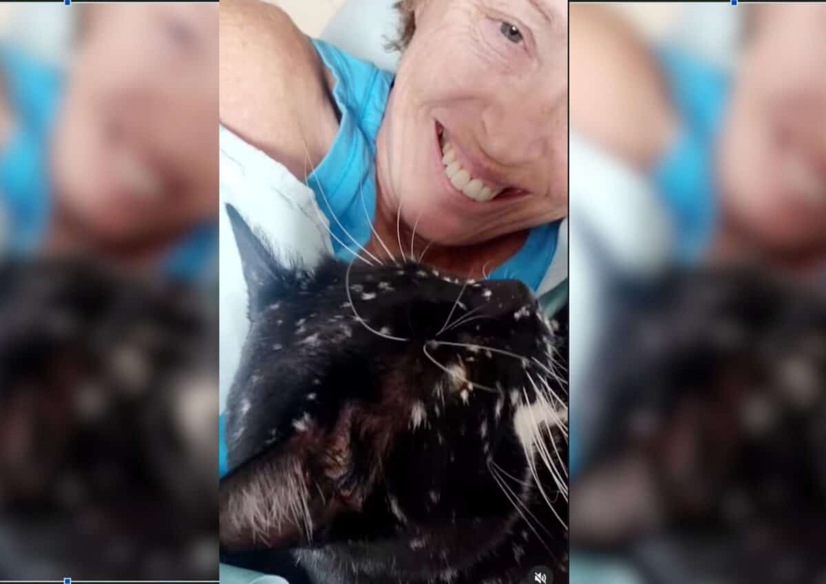 Gatsby cuddles with his owner, Jean.