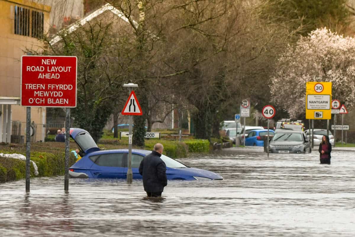 People wading through floodwater in Cardiff, Wales, 2020