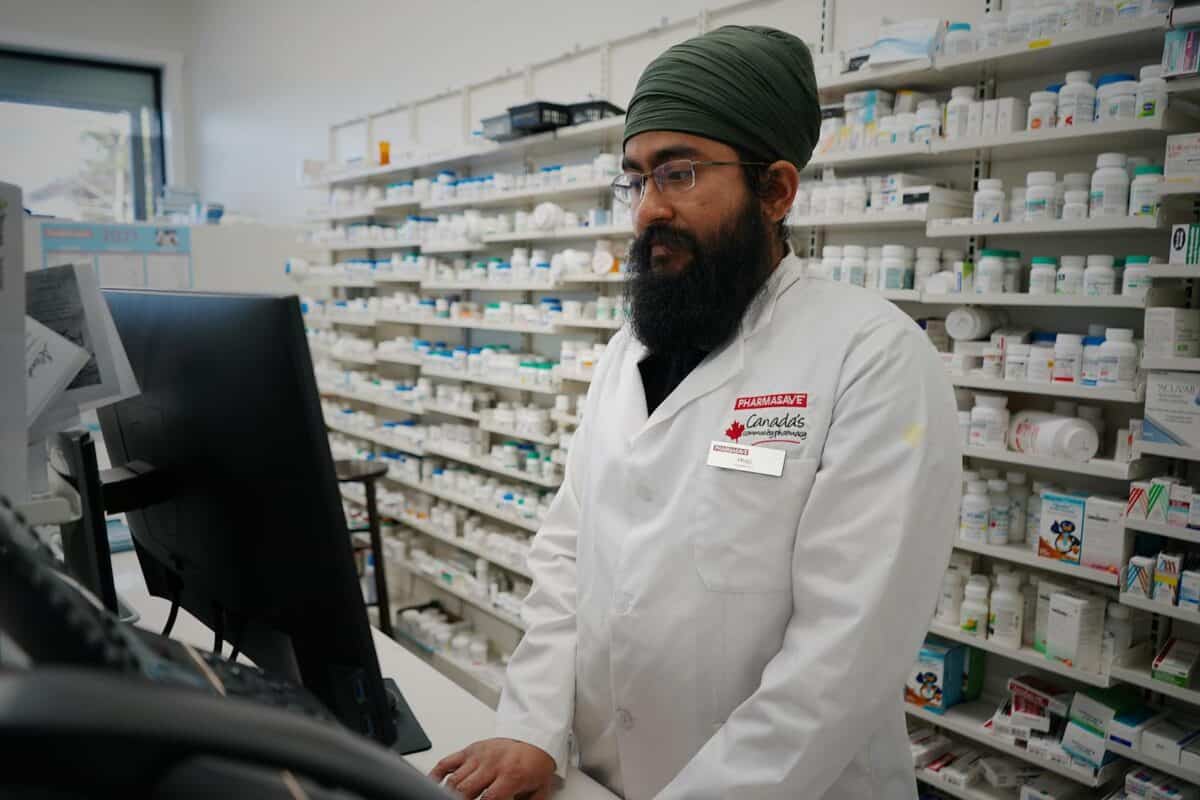 Pharmacist working at a computer in a pharmacy store