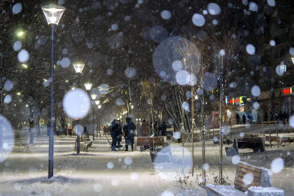 City view, lights, falling snow,