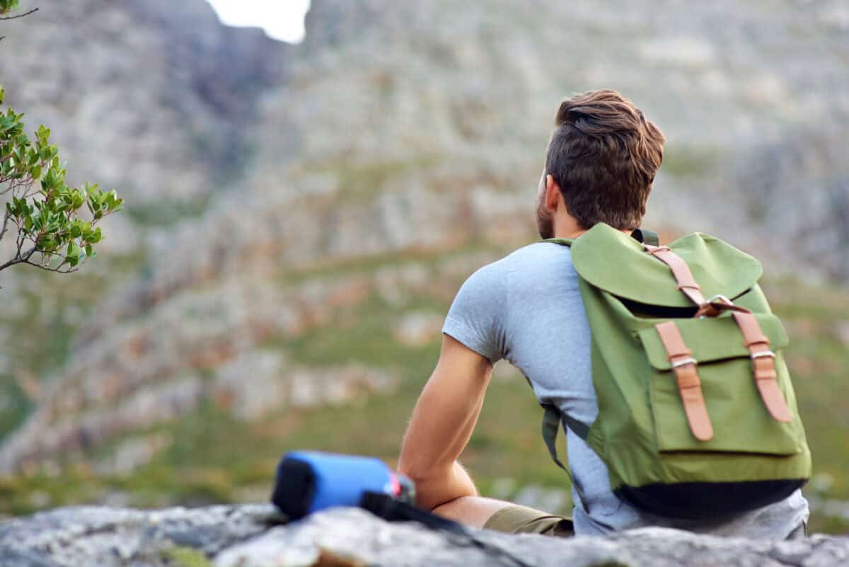 Enjoying the outdoors. a handsome young man enjoying the view while hiking.