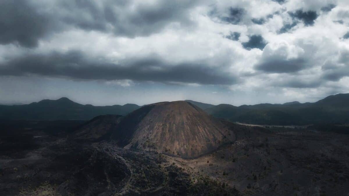 brown mountain under white clouds during daytime