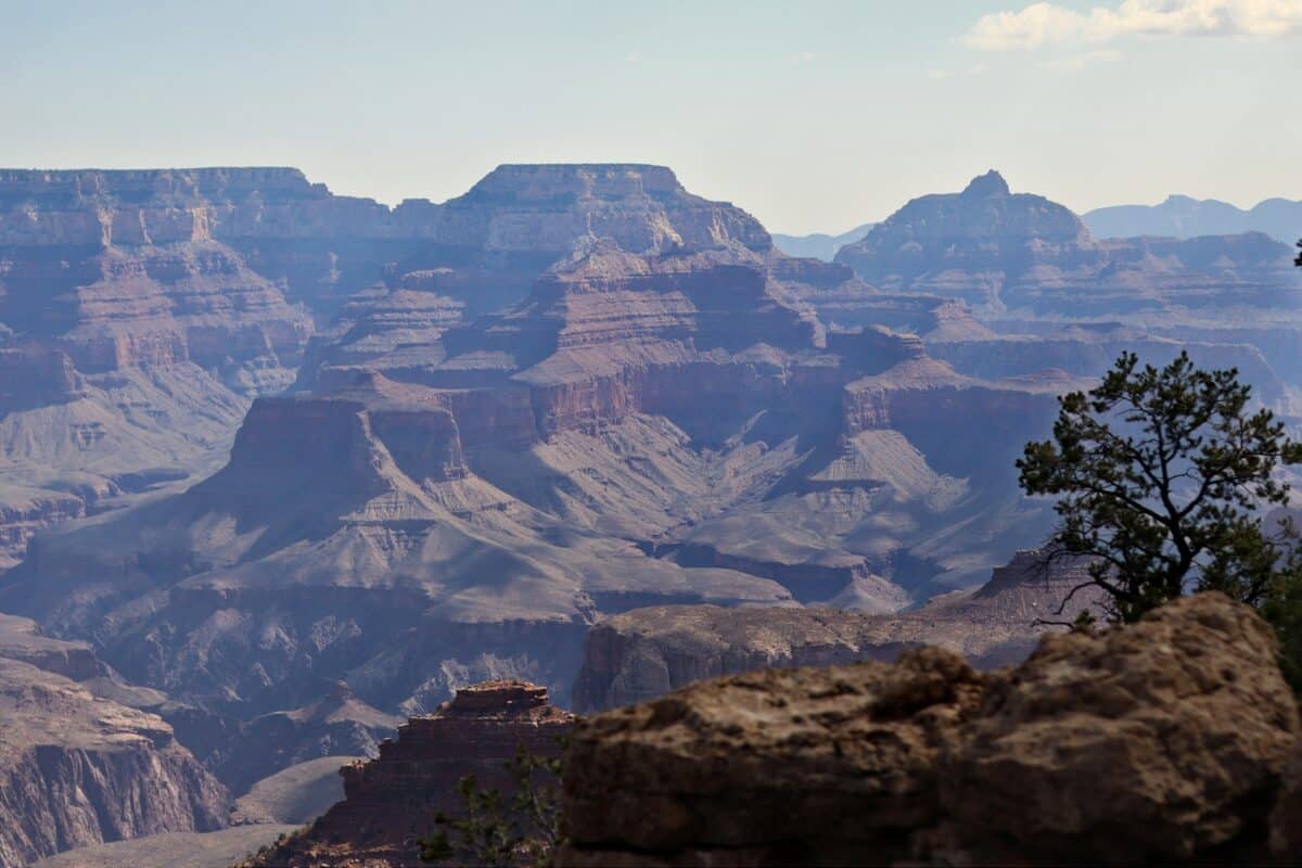 A man standing on top of a large cliff