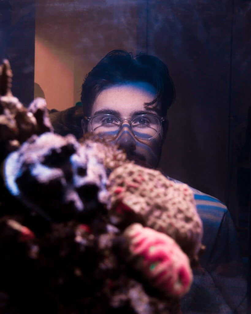 woman in blue and black jacket holding brown and black leopard plush toy
