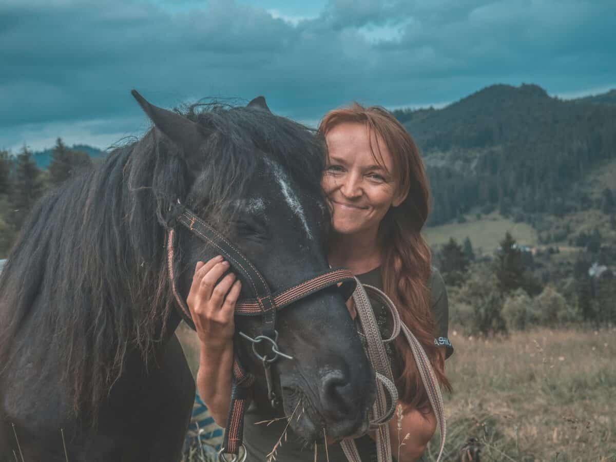 woman holding horse