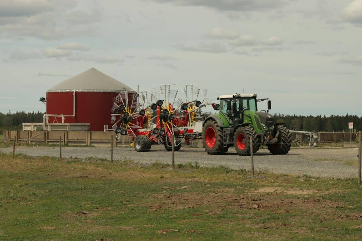 A modern tractor with rakes at a farm in Jönköping, Sweden captures the essence of contemporary agriculture.