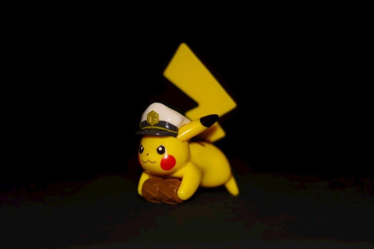 A pikachu figurine is posed in a dark room