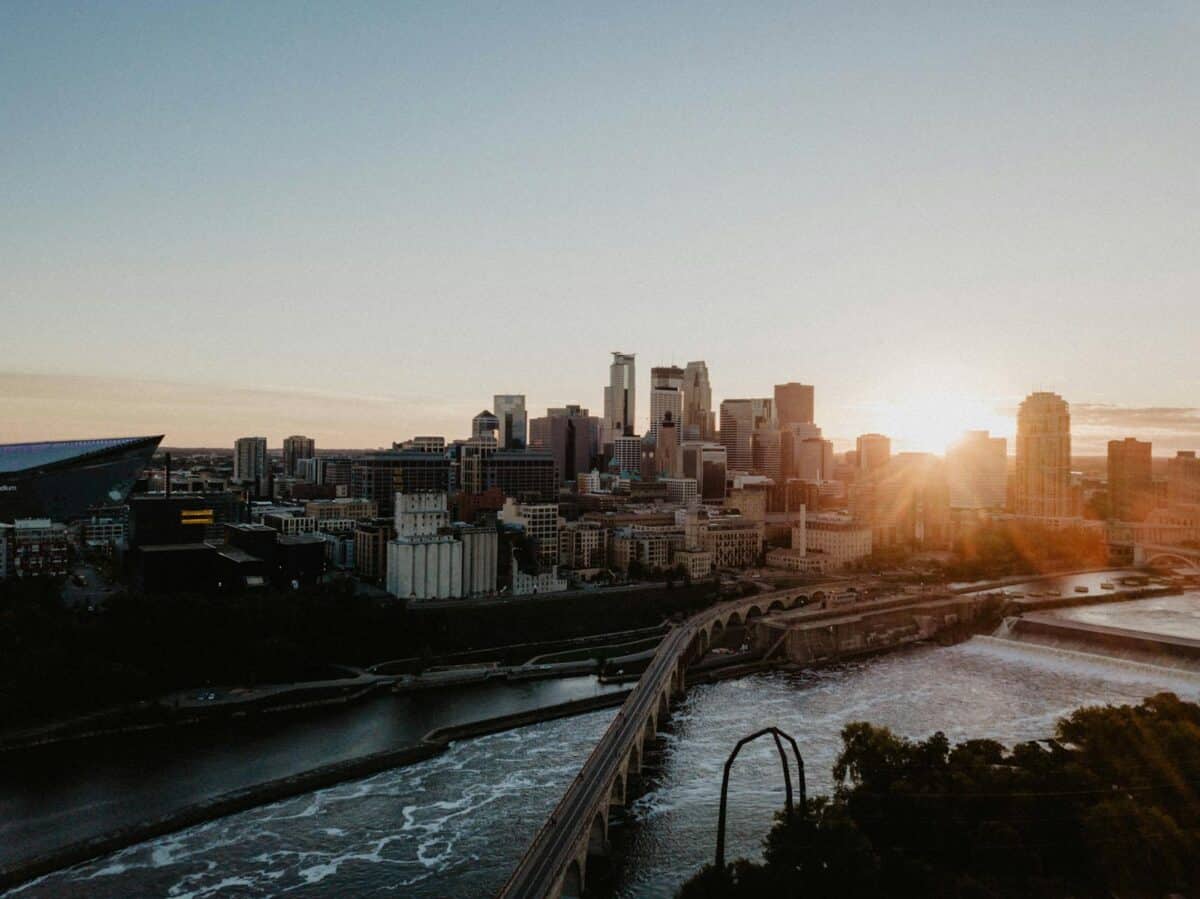 A breathtaking aerial view capturing the Minneapolis skyline with a scenic sunset backdrop.