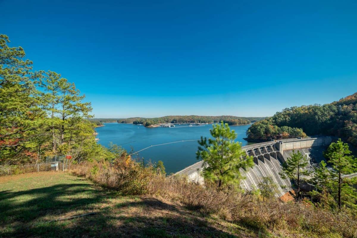 Serene view of Allatoona Dam and Lake in Cartersville, Georgia with lush greenery.