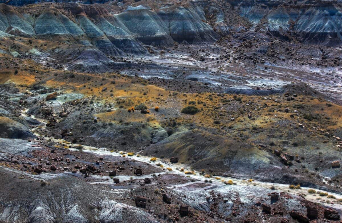 brown and gray hills with stones at daytime