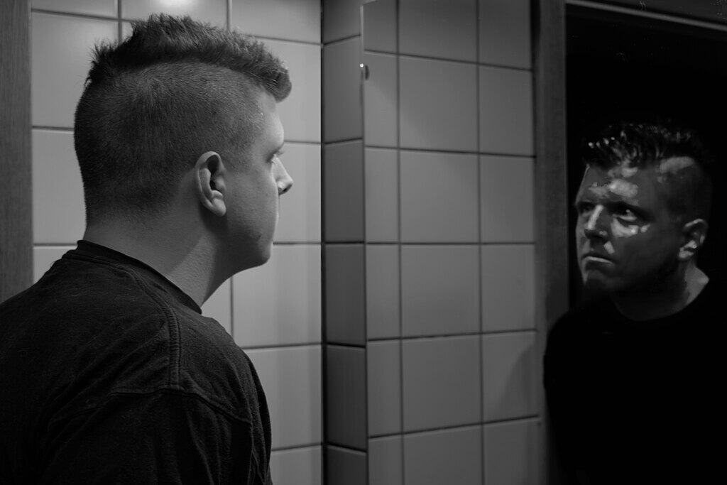 Man with their reflection in mirror