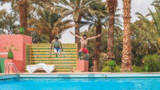 Men enjoying the ambiance of the pool.