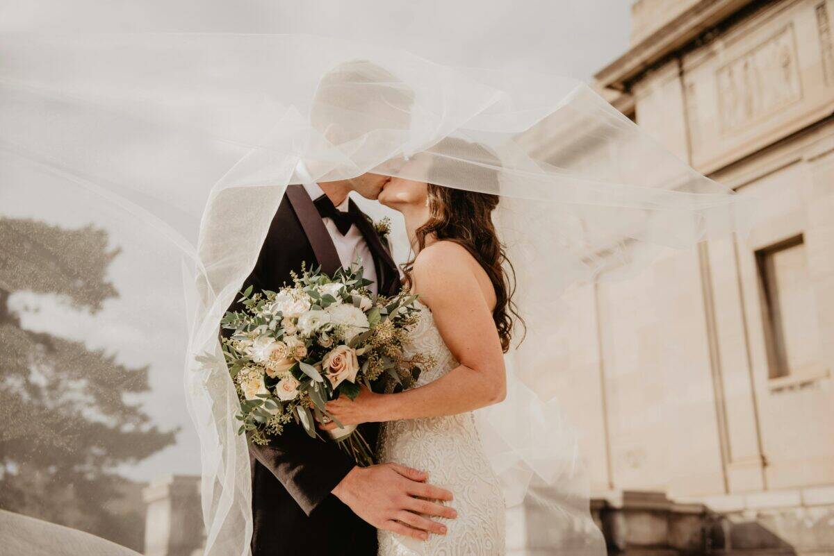 A couple kissing on their wedding day.