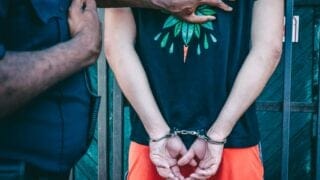 A man handcuffed after getting arrested.