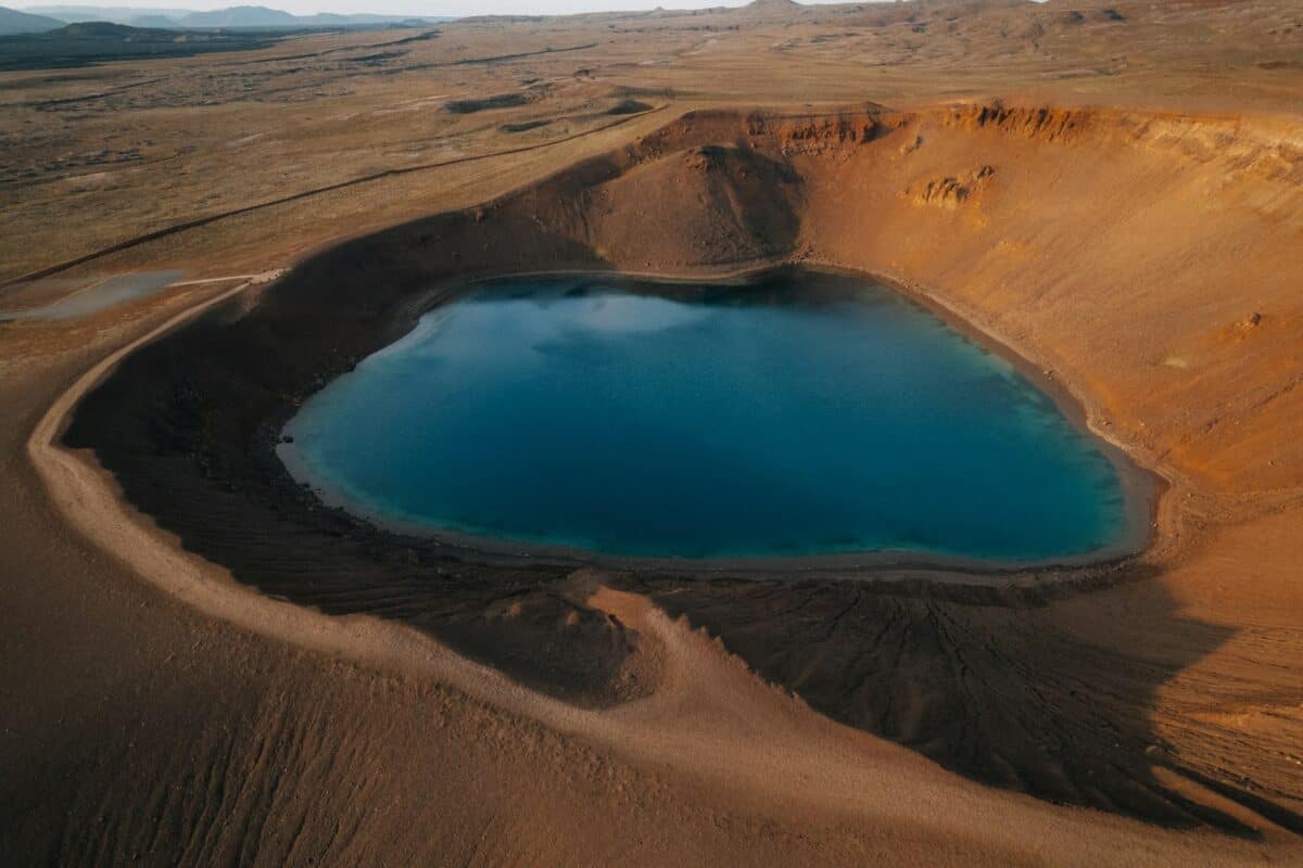 a large blue lake in the middle of a desert