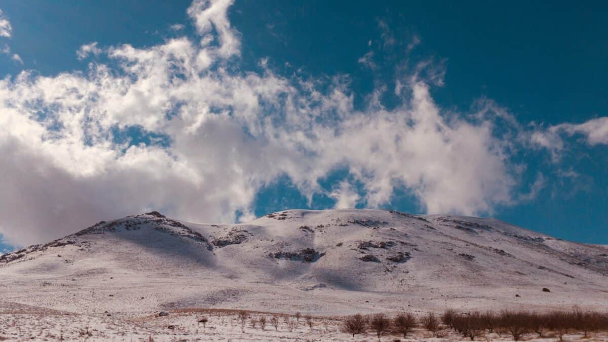 mountain under white cloudy skies