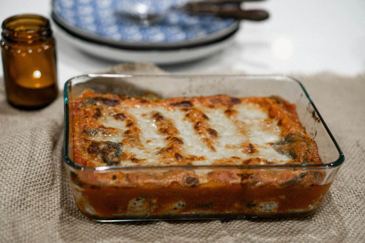 A newly-cooked lasagna in a tray.