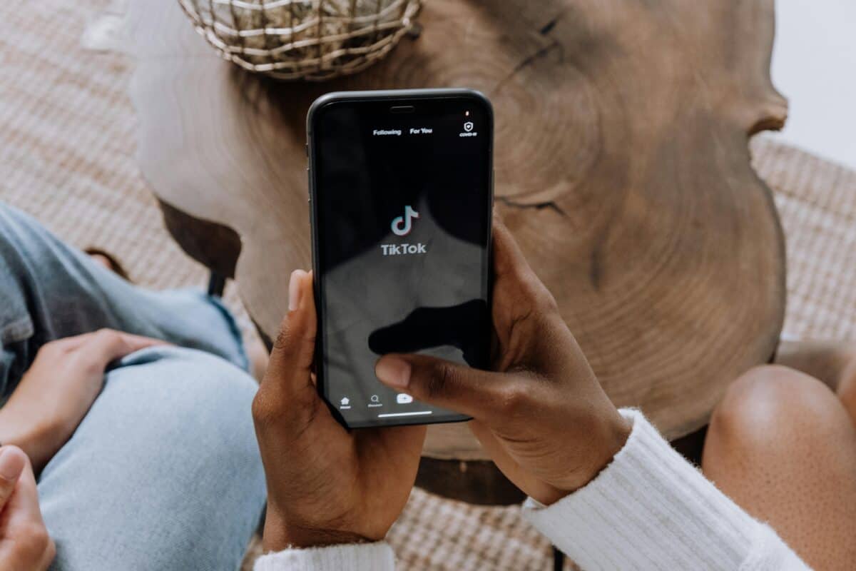 A person holding his phone while using TikTok.