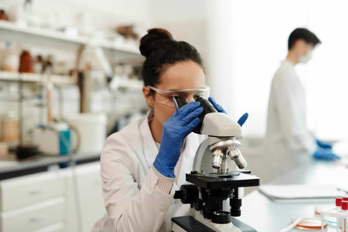 A scientist using a microscope.