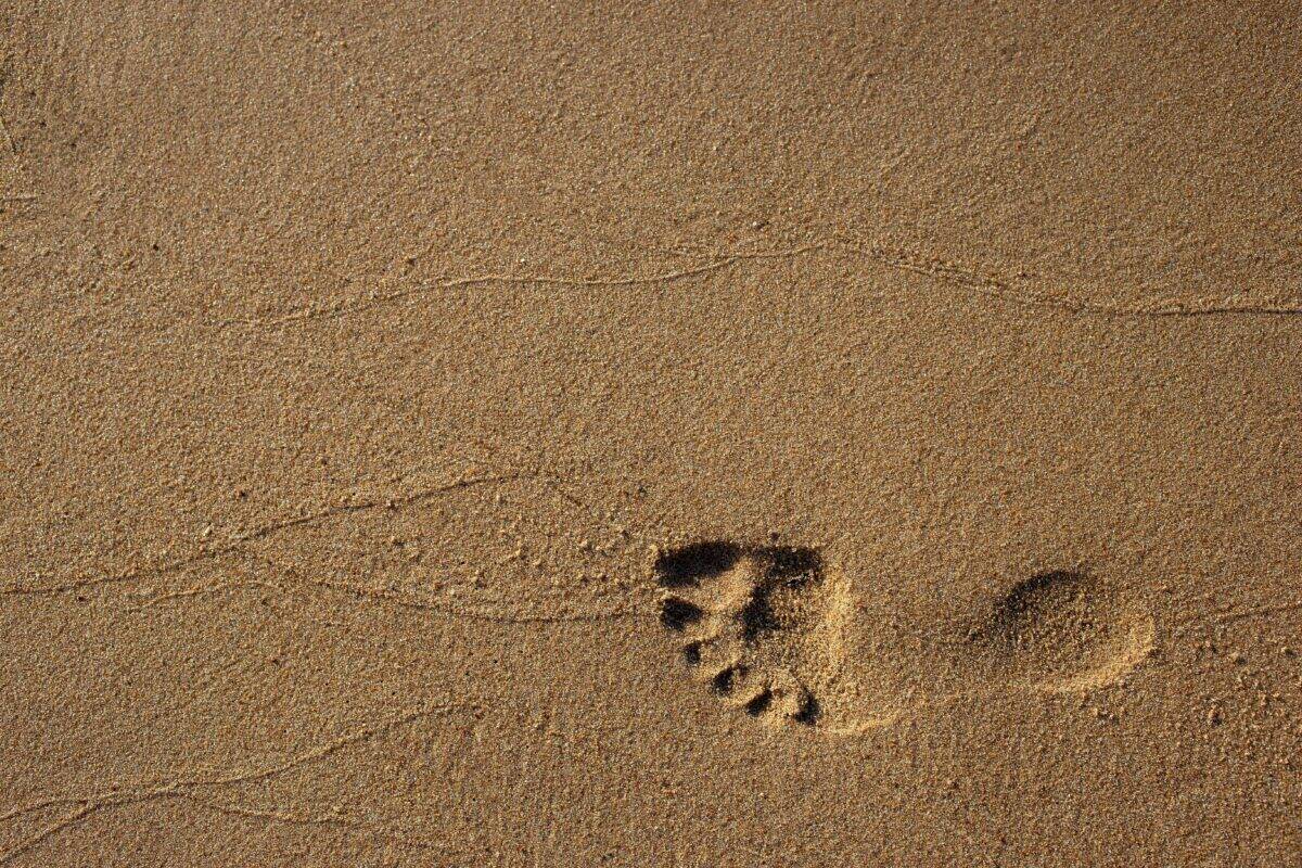 A massive footstep of a person in the sand.