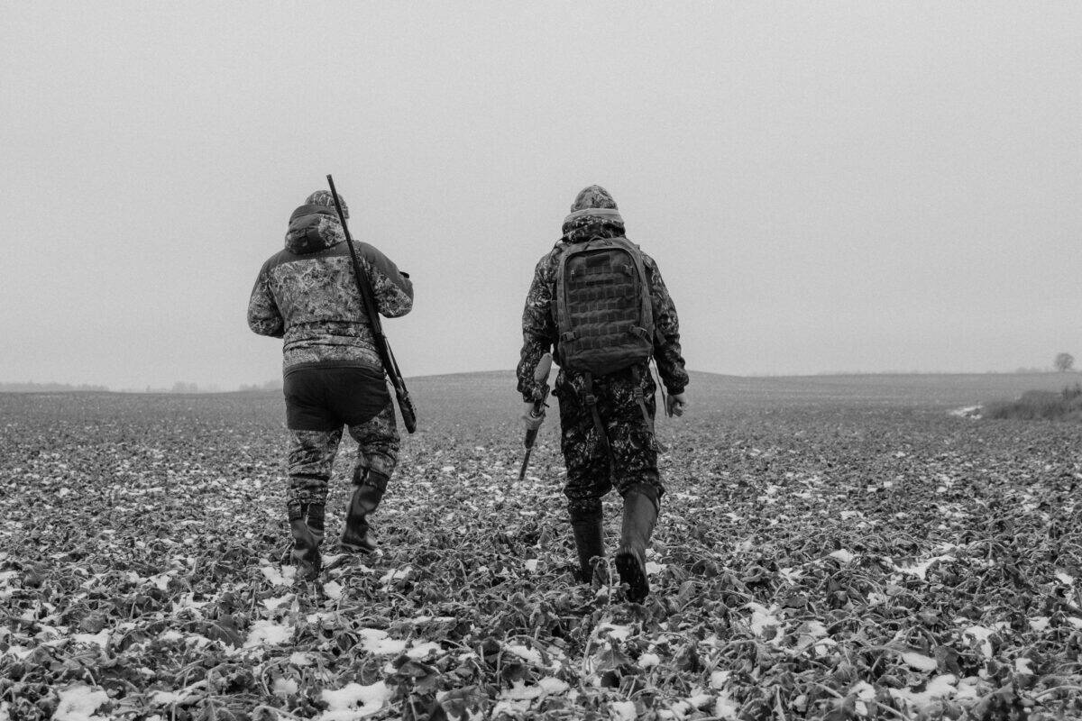 Two men in full battle gear are ready for hunting.