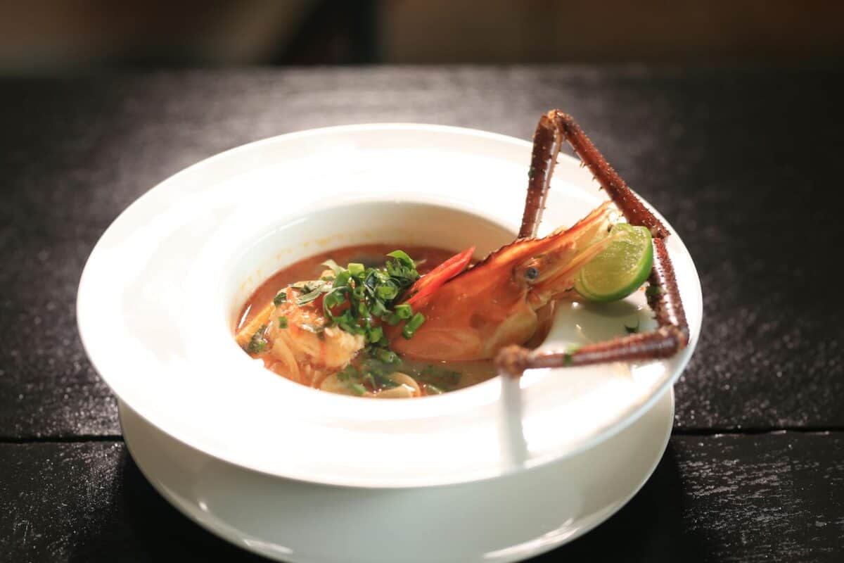 Savor a flavorful Cambodian seafood soup featuring fresh lobster and lime in Phnom Penh.