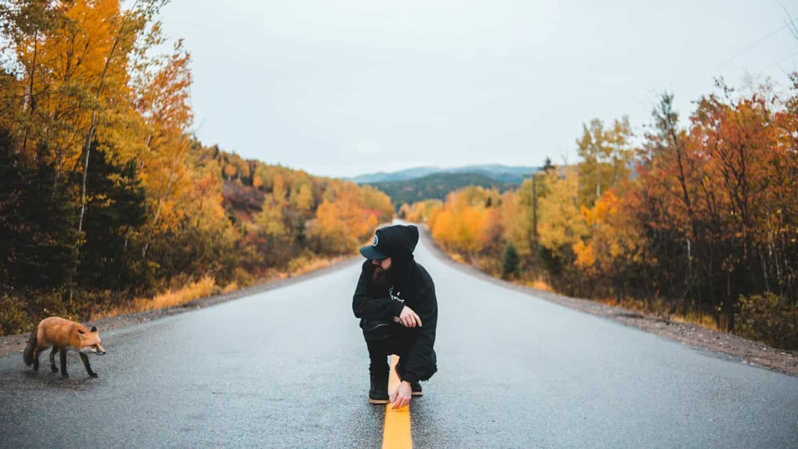 person siting between road