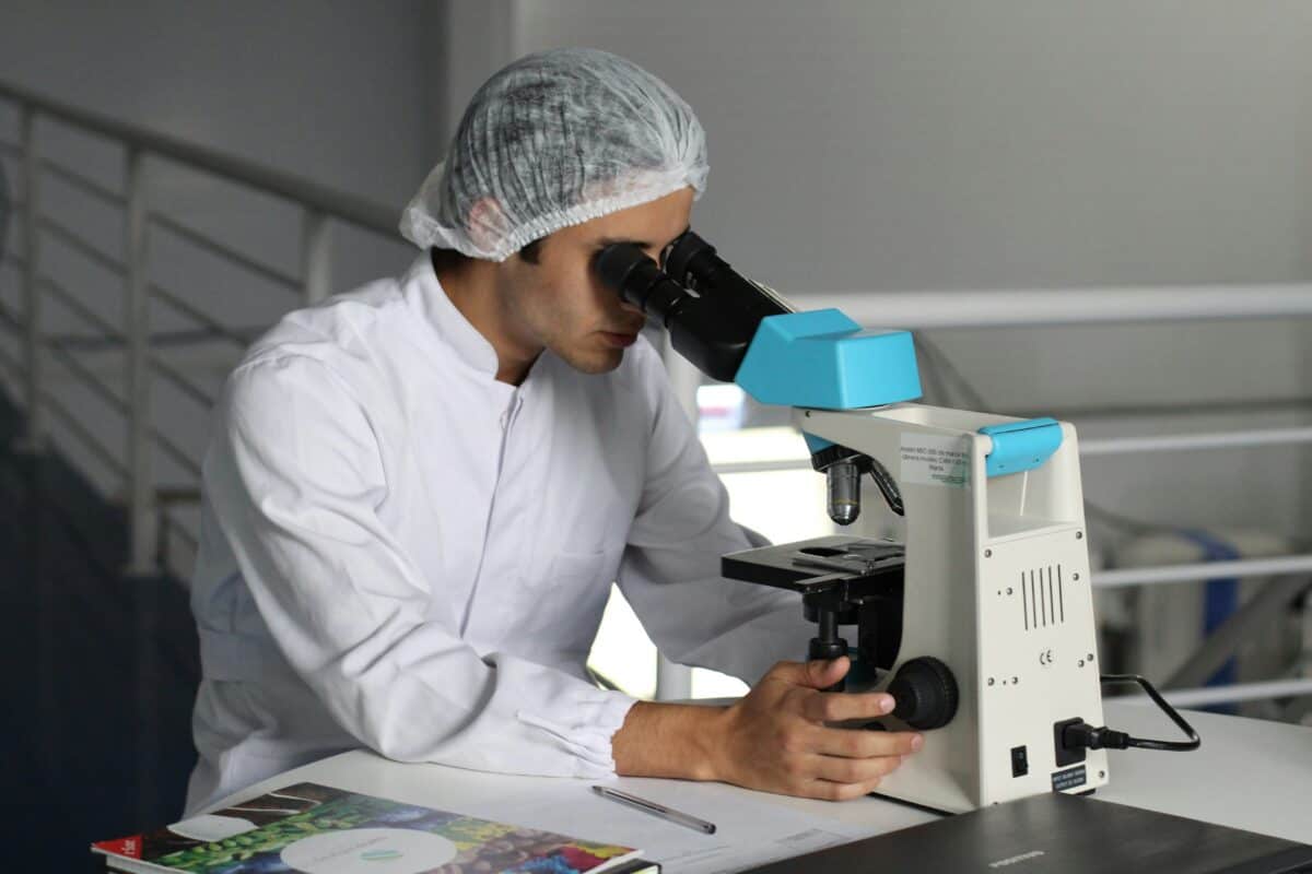 A medical professional using a microscope.