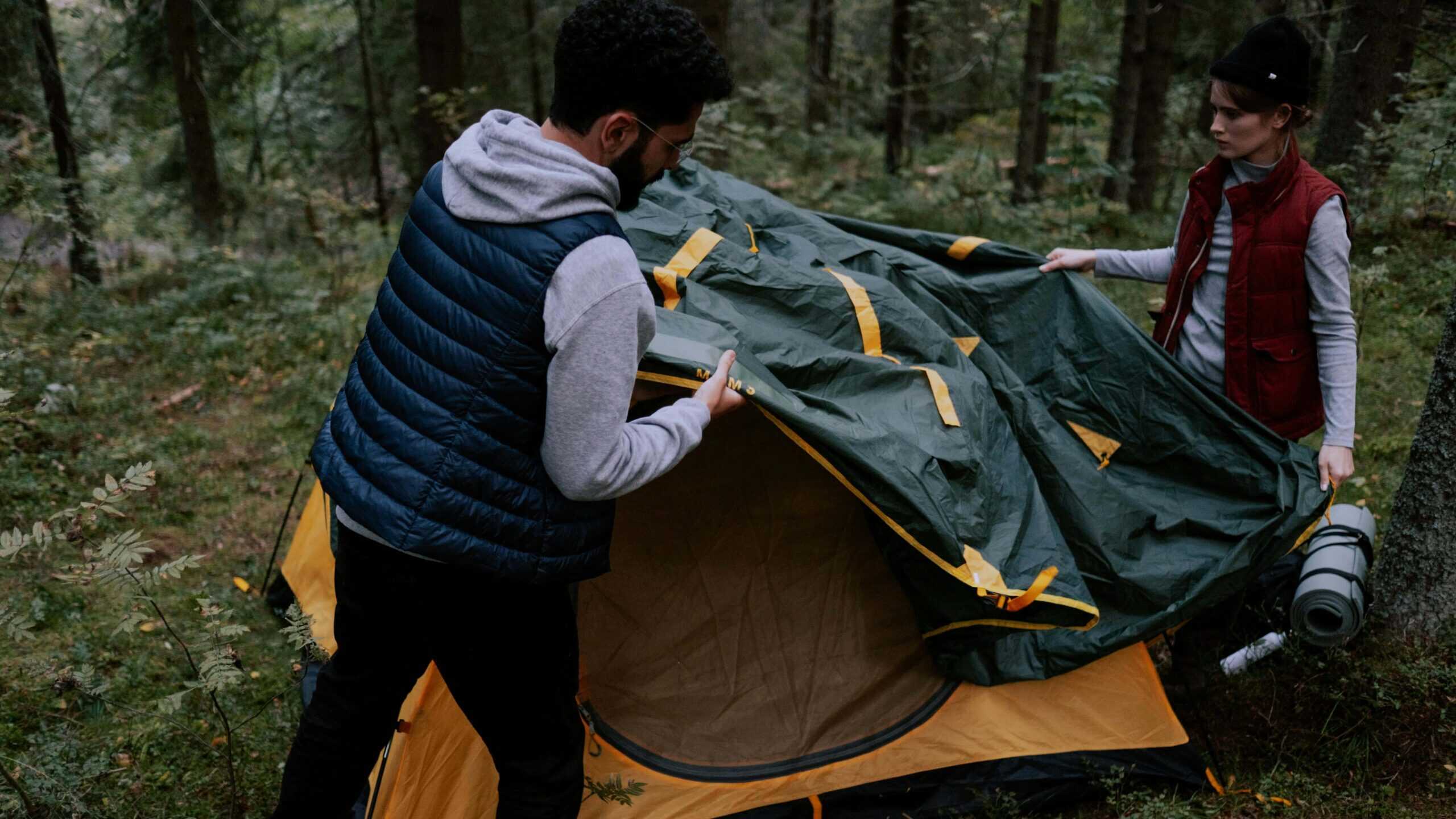 Outdoor adventurers set their tent for shelter and protection.