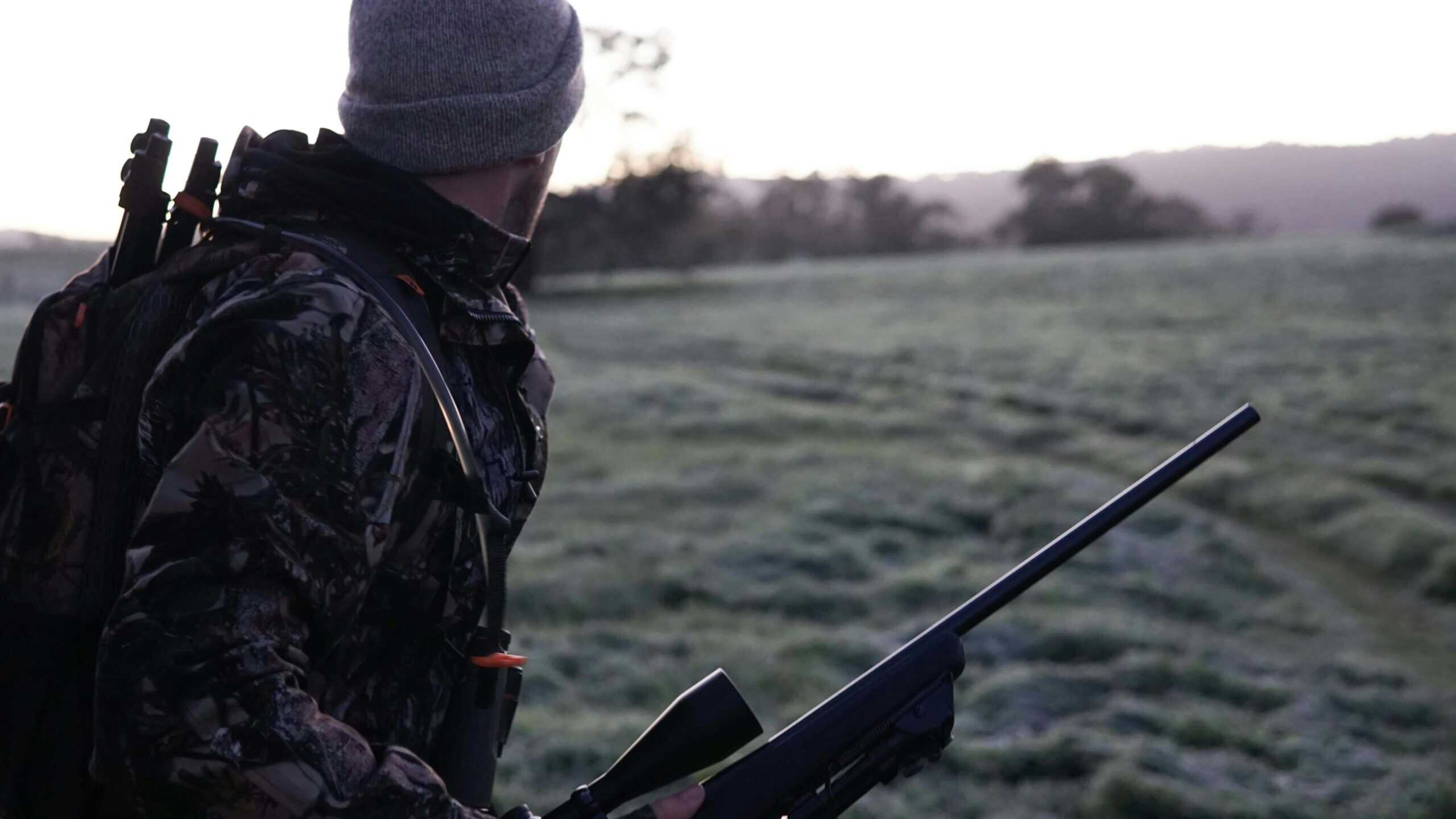 A man wearing full hunting gear.