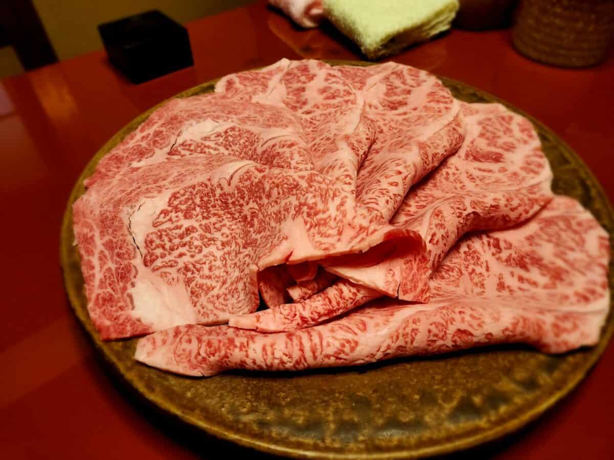 A plate of raw meat sitting on a table