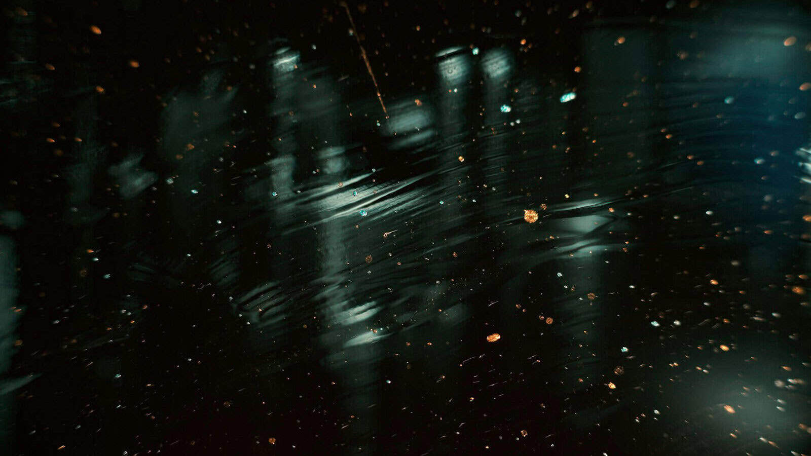 a blurry image of rain falling on the ground