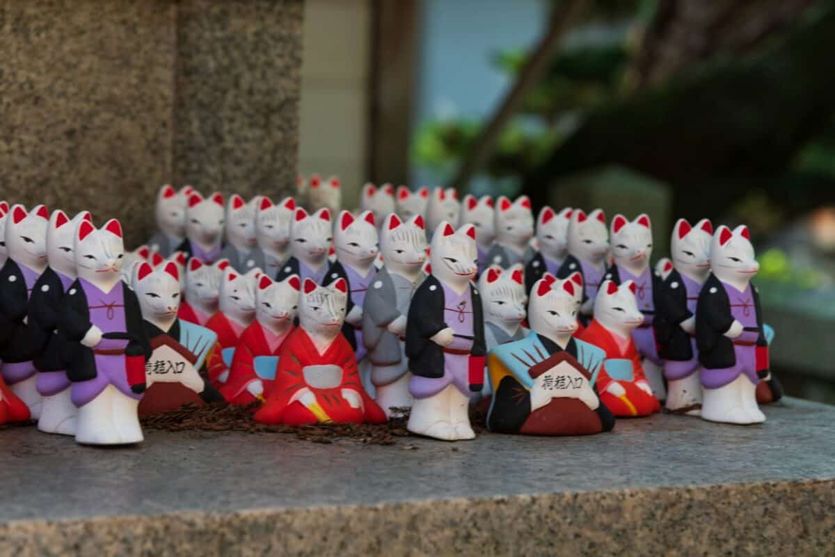 A group of toy figurines are lined up on a ledge