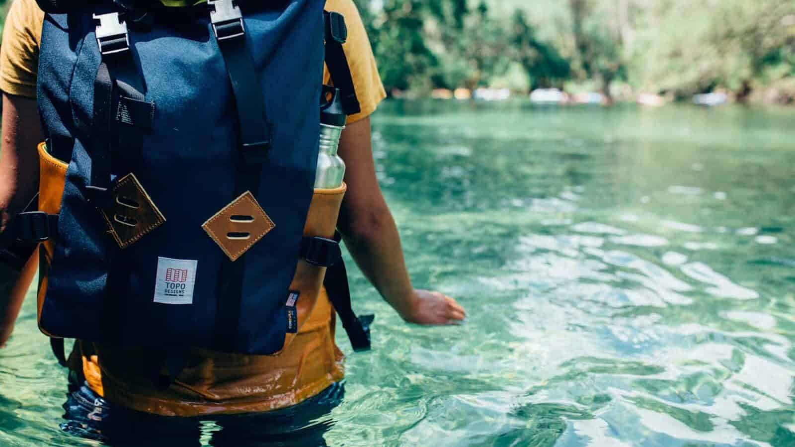 person crossing the river during daytime