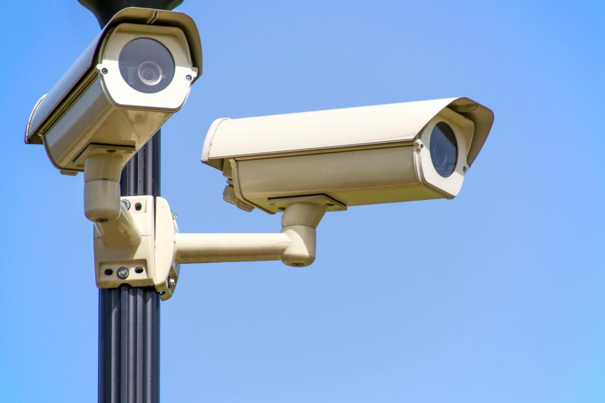 Surveillance cameras integrated on a post.