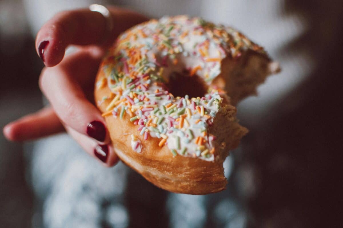 A strawberry-flavored doughnut with a bite.