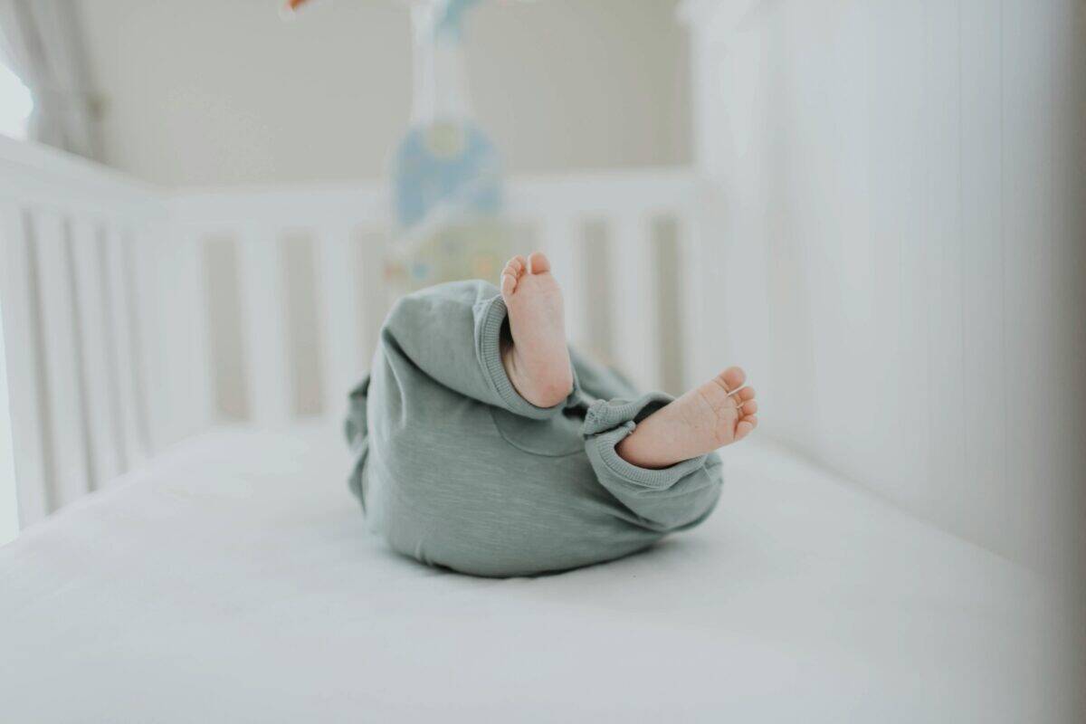 A baby inside a crib.