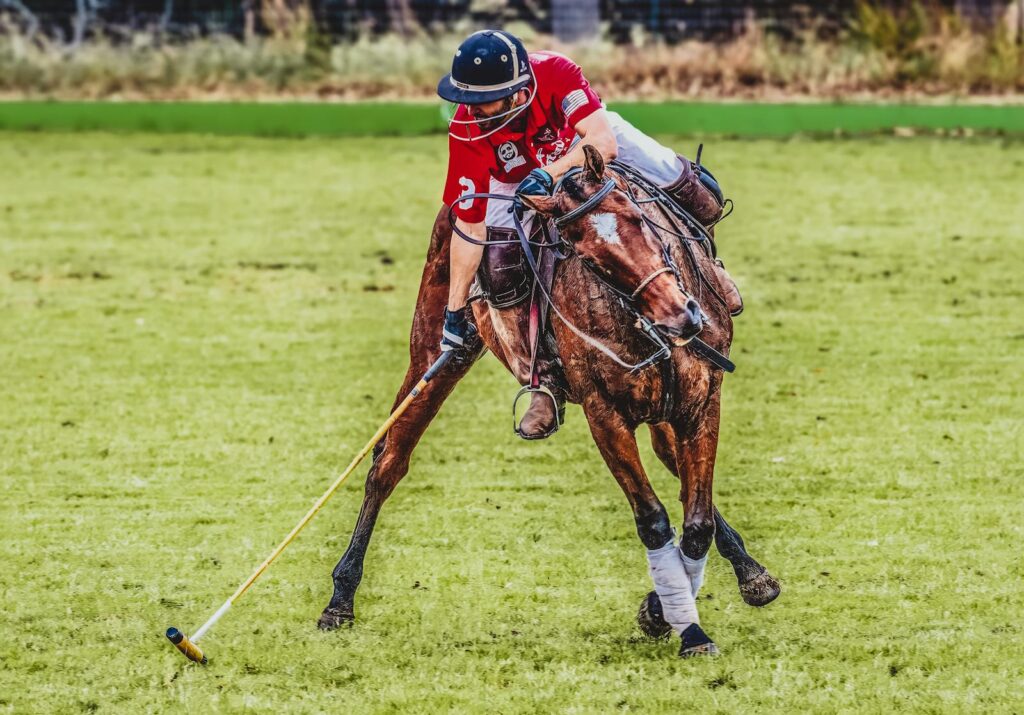 Intense polo match scene with a player skillfully maneuvering his horse on the field.