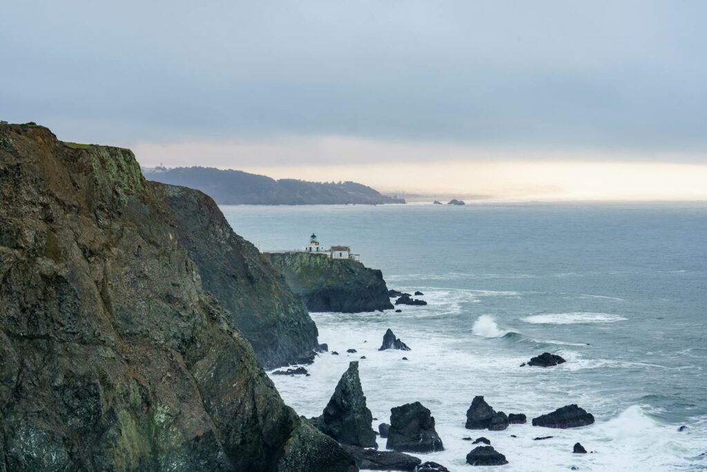 Dramatic landscape of Point Bonita Lighthouse on rugged cliffs by the ocean in San Francisco.