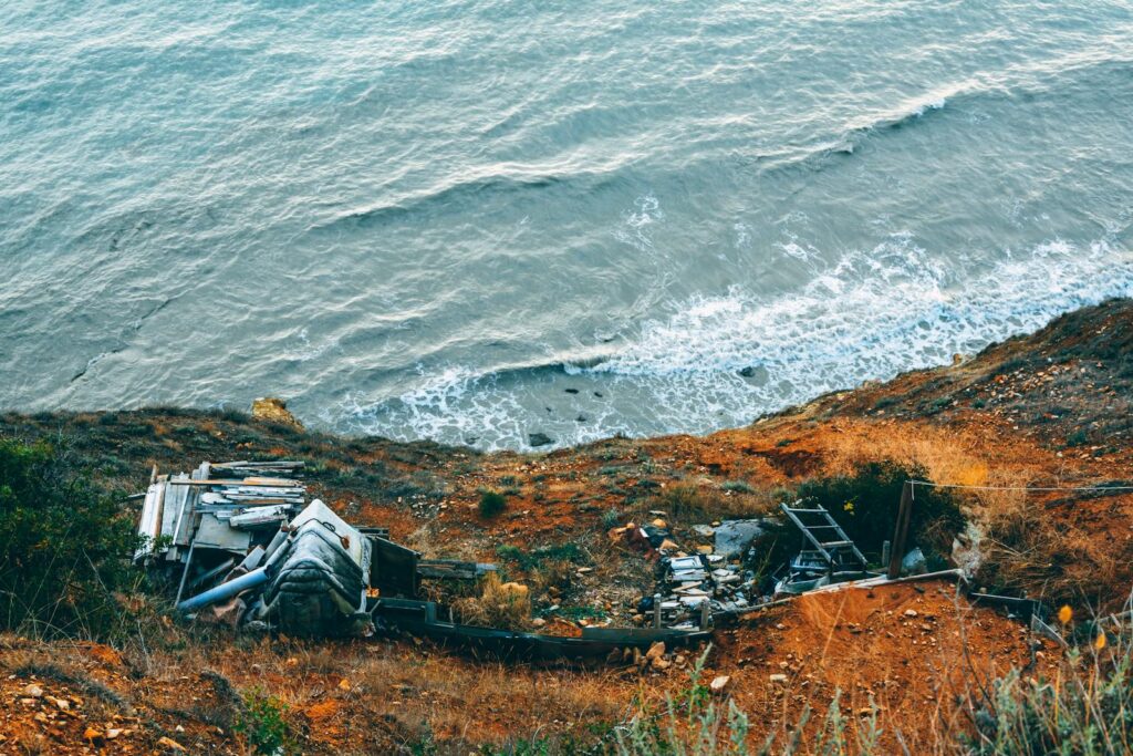 Abandoned structures on the scenic coastline showing erosion effects.
