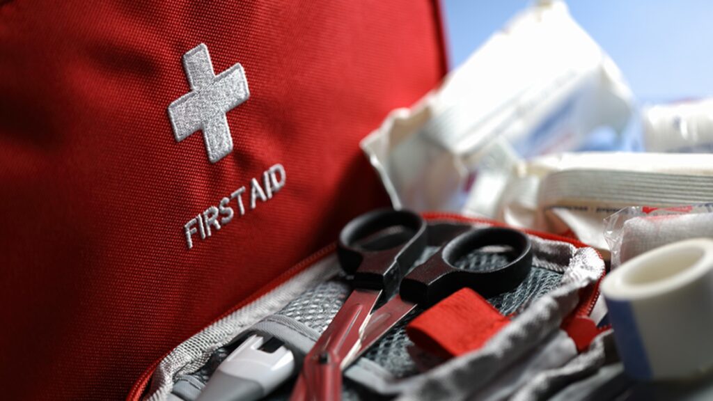 First aid kit featuring scissors, assorted bandages, and necessary items for immediate medical assistance.
