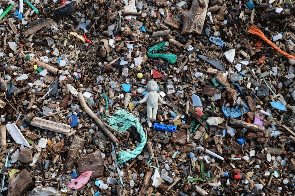 small pieces of broken down plastic materials washed up on shore