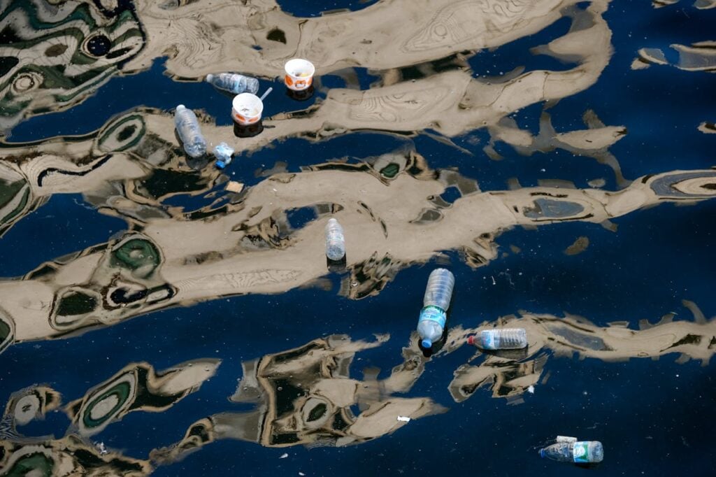 plastic bottles and containers floating on water