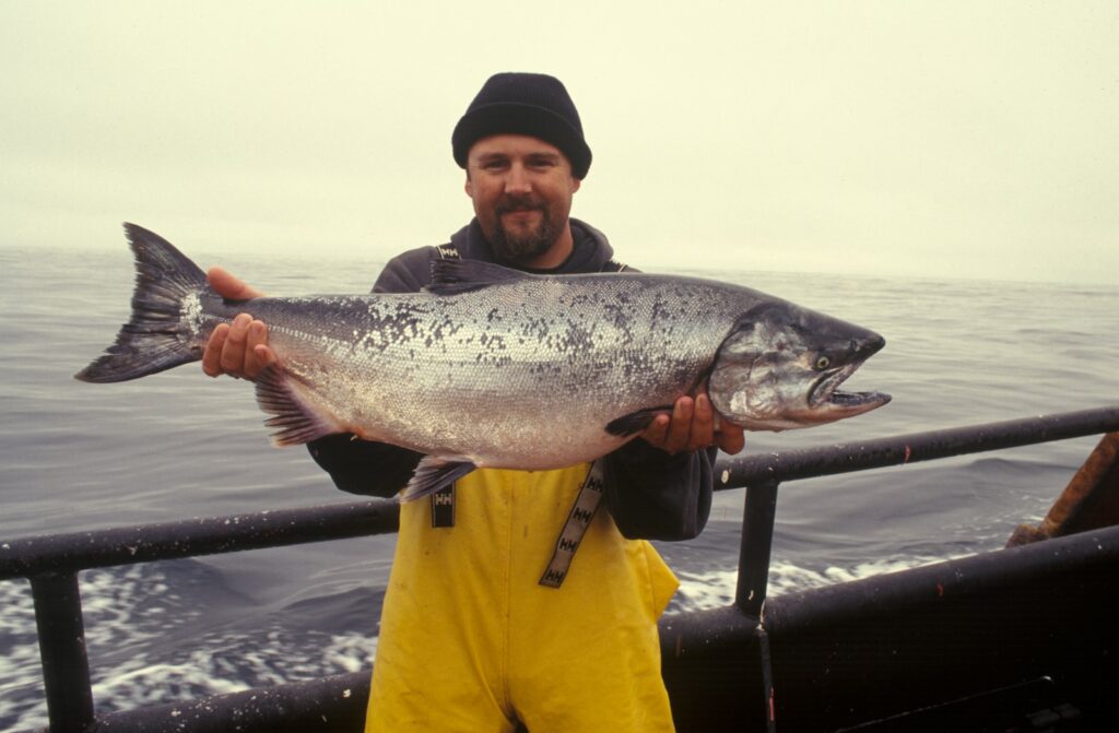 scientist carrying silver fish